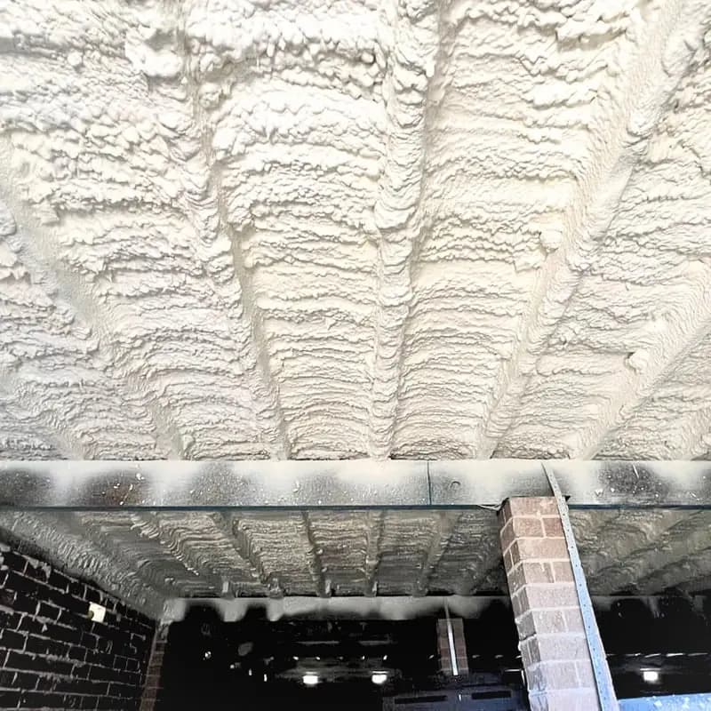 Freshly sprayed insulation on a residential ceiling